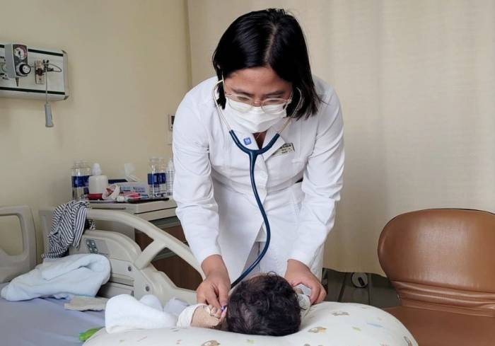 Bác sĩ chuyên khoa Nhi đang khám cho bé An. Ảnh: Vũ Hoàng