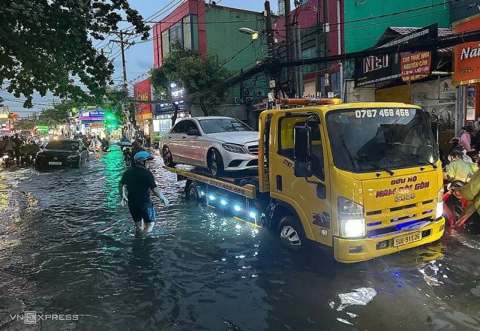Ôtô chết máy được xe cứu hộ đưa đi trên đường Nguyễn Văn Quá - cửa ngõ Tân Sợn Nhất, chiều 30/9. Ảnh: Tuấn Việt