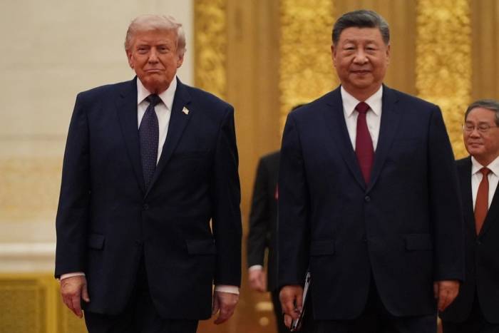 Chủ tịch Tập và Tổng thống Trump tiến vào tiệc chiêu đãi tại Đại lễ đường Nhân dân tối 14/5. Ảnh: AP