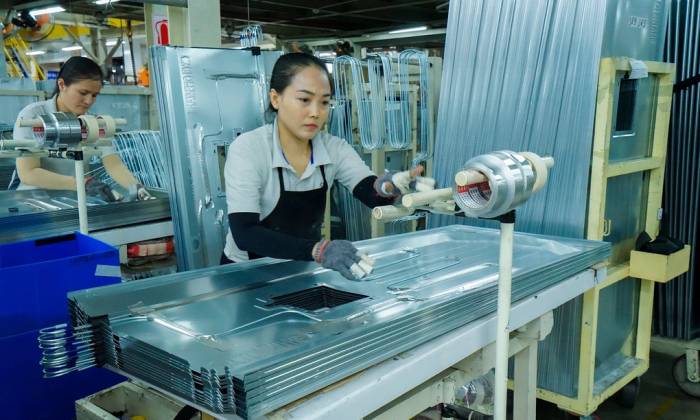 Các công nhân bên trong nhà máy sản xuất máy giặt/tủ lạnh của nhà máy Aqua tại Biên Hòa (Đồng Nai). Ảnh: Bảo Lâm
